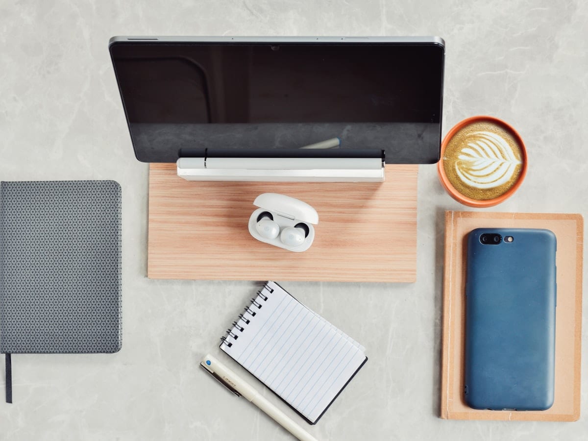 An ordered desk with notebook and laptop